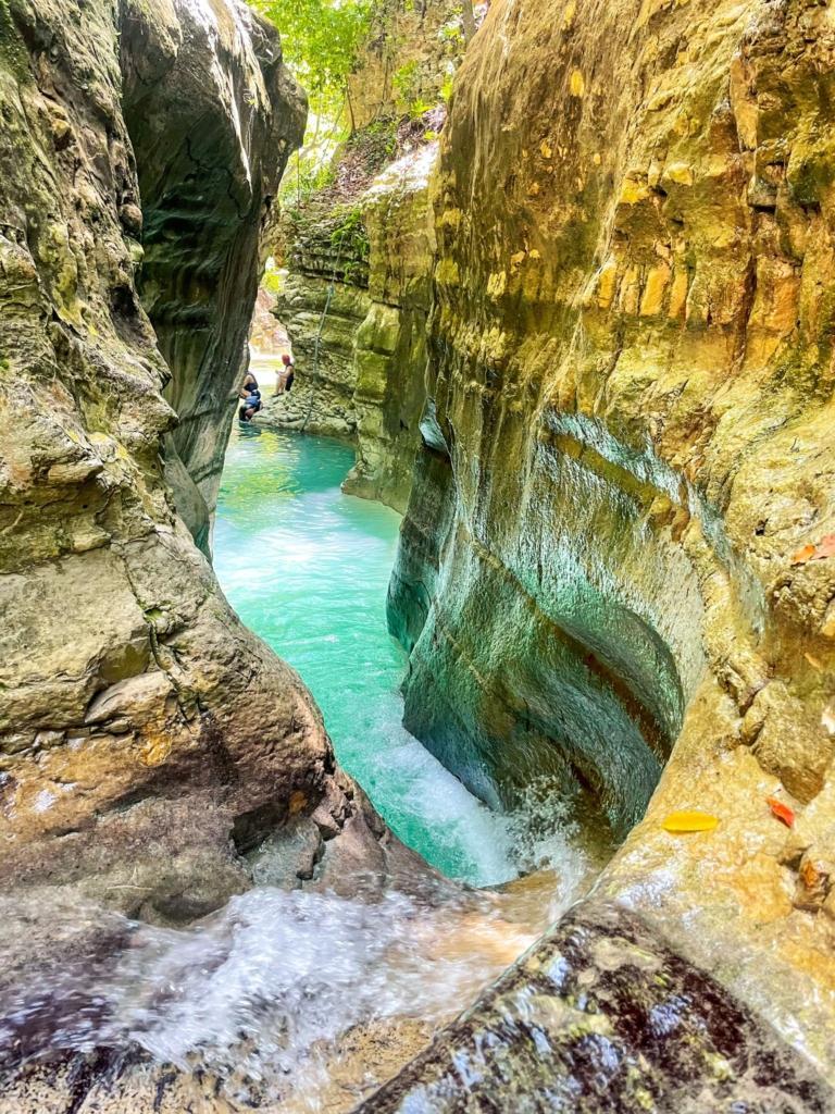 Waterfalls cascading into a natural pool surrounded by tropical forest