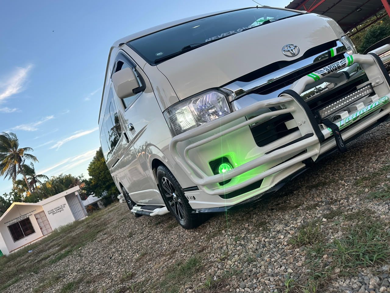 White Toyota Hiace van gleaming at golden hour