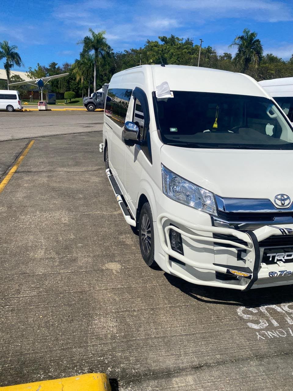 White Toyota Hiace van parked at the airport