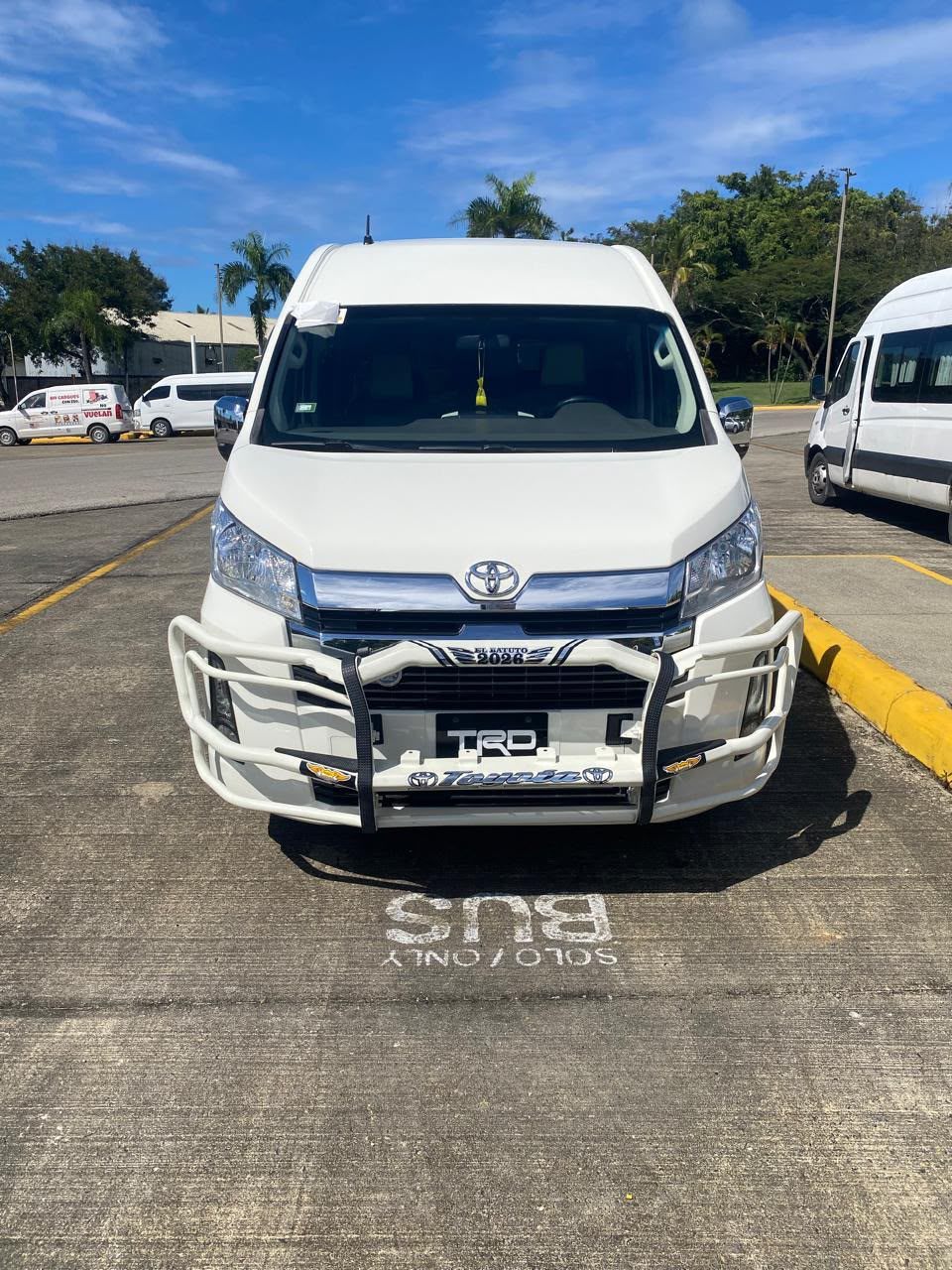 White Toyota Hiace van facing the camera at the airport