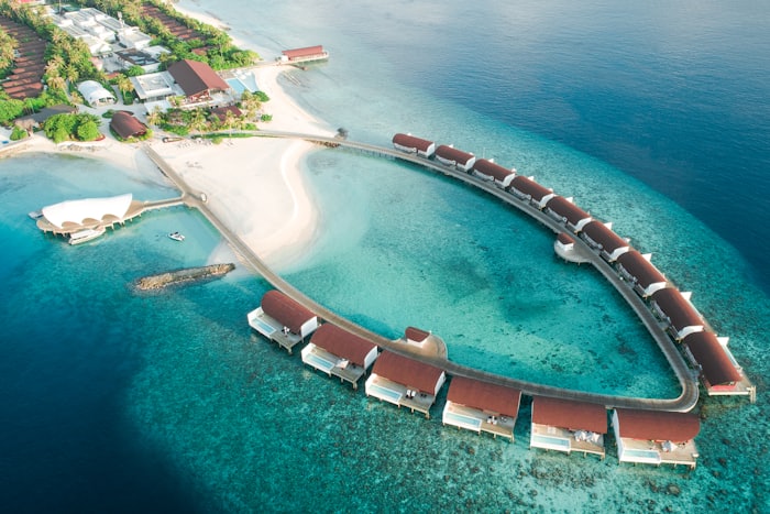 Aerial view of overwater villas on turquoise sea
