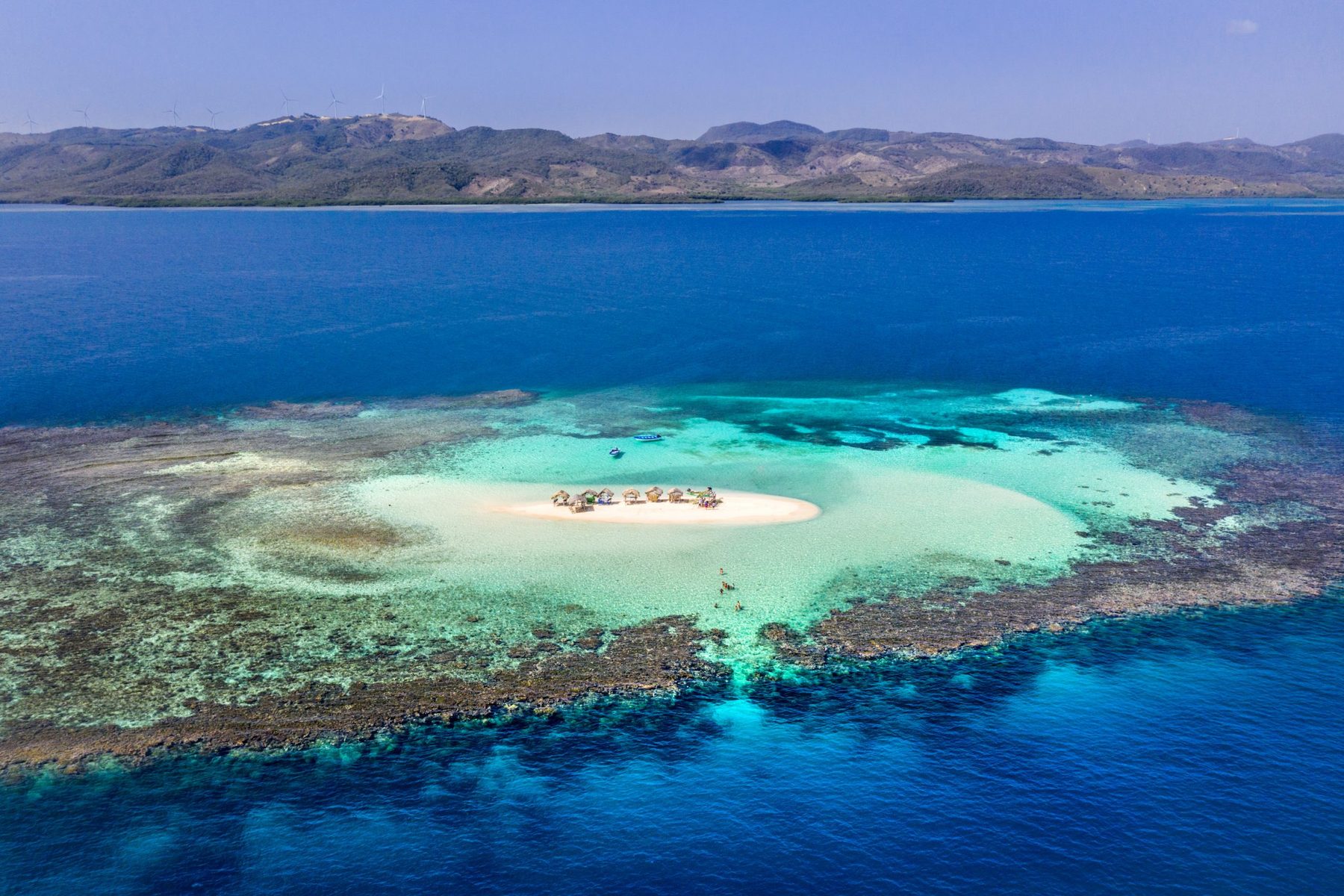 Aerial view of Cayo Arena, a white sandbar ringed by turquoise reef on the Dominican north coast