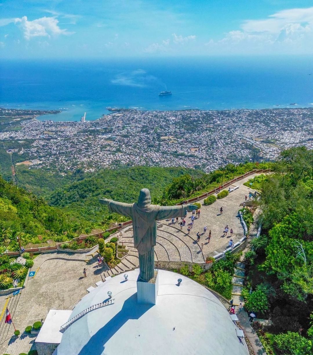 The Christ the Redeemer statue on Pico Isabel de Torres looking down over Puerto Plata, its bay and a cruise ship offshore